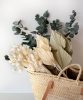 panier en osier remplit de bottes de fleurs séchées